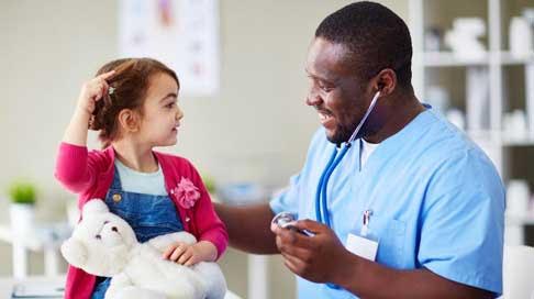 A doctor monitoring a child